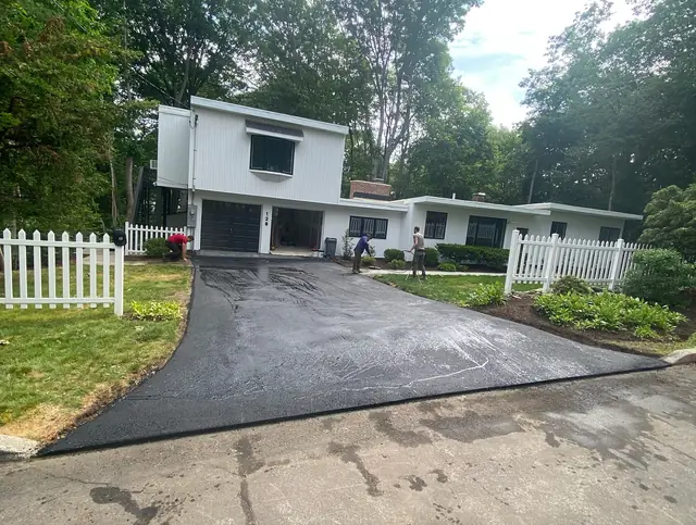 Same driveway after resurfacing with a fresh asphalt overlay