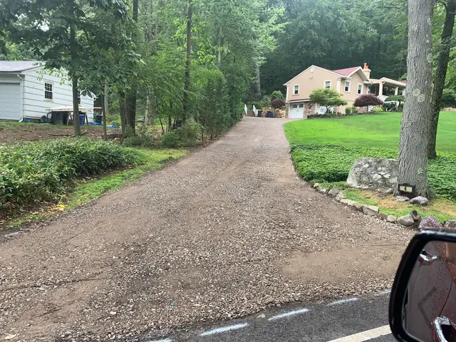 Graded and compacted gravel base ready for driveway paving