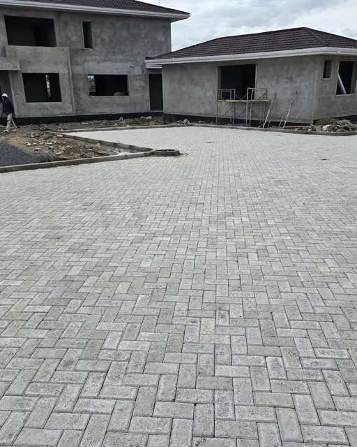 Close view of herringbone paver pattern on a new driveway