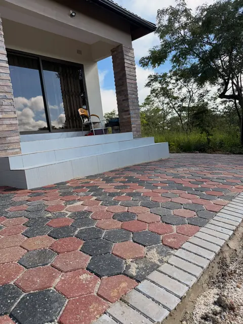 Hexagon paver landing at the entry steps of a modern home