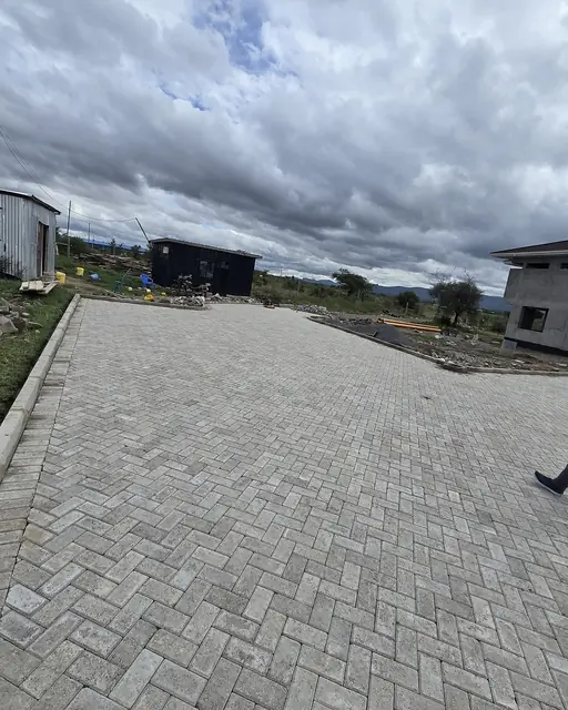 Large gray herringbone paver driveway nearing completion