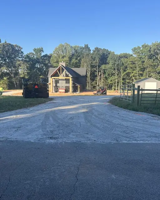 Compacted stone base on a long driveway ready for paving