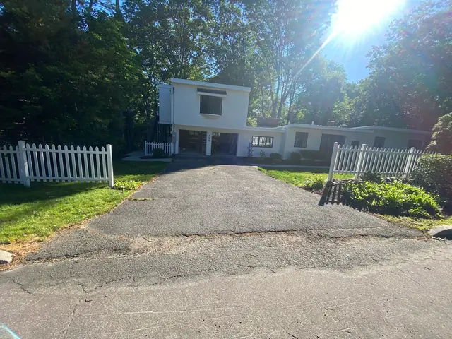 Worn and faded asphalt driveway before resurfacing